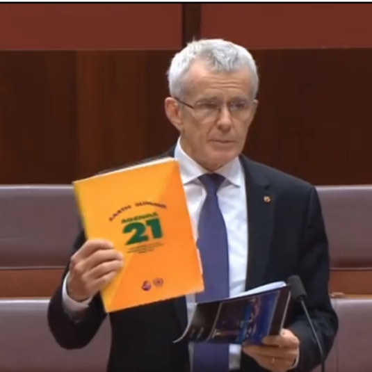 Senator Malcolm Roberts holds a copy of Agenda 21.