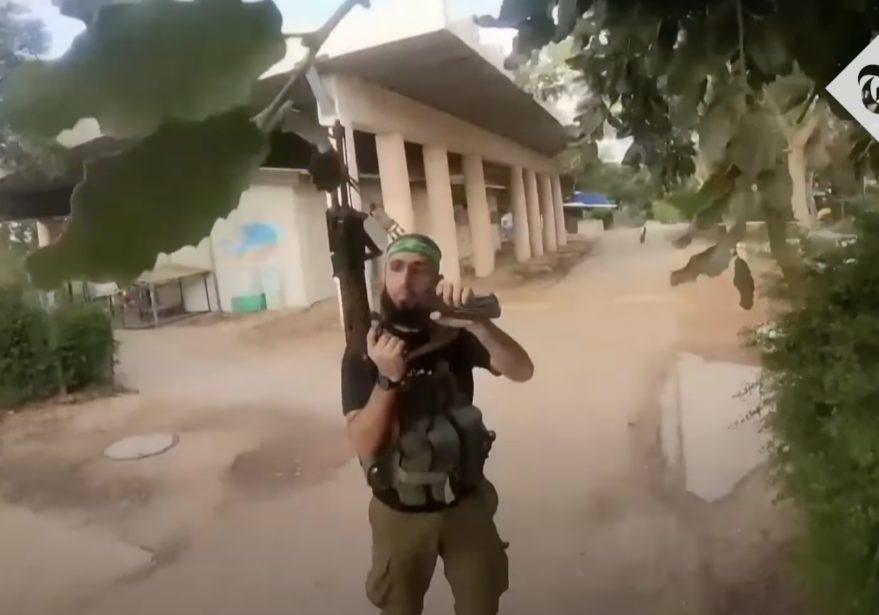 A Hamas gunman reloads to continue the rampage (screenshot)