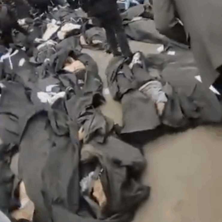 Iranians gather around the bodies of murdered protesters (Image: Screenshot)