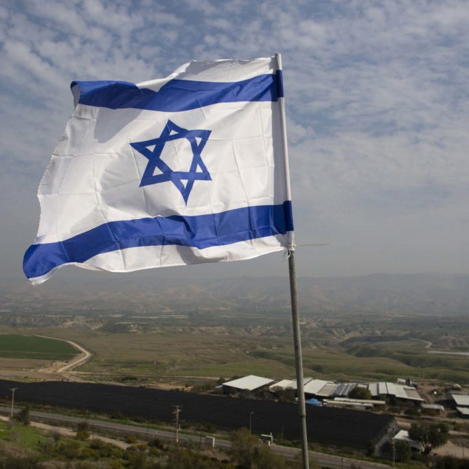An Israeli flag flies in a Jordan Valley Jewish settlement.  CREDIT: GETTY IMAGES
