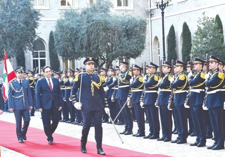 Lebanon's new PM Hassan Diab reviews an honour guard at the government palace in Beirut earlier this week (photo credit: REUTERS)