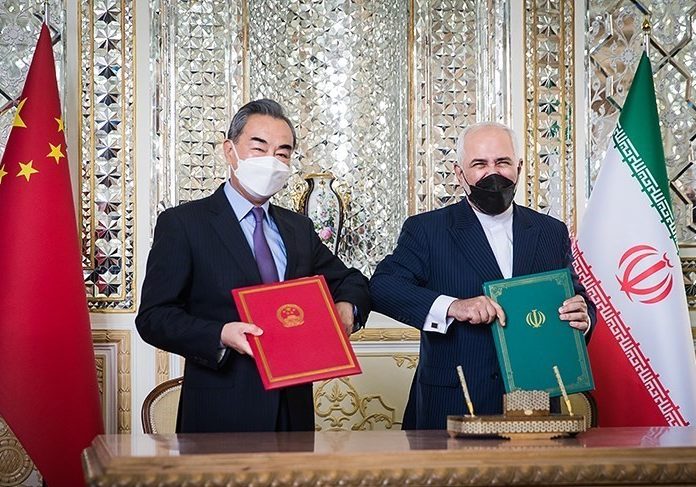 Iranian Foreign Minister Mohammad Javad Zarif and State Councilor of the People’s Republic of China Wang Yi signing the Iran–China 25-year Cooperation Program in Teheran on March 27 (Photo: Wikimedia Commons)