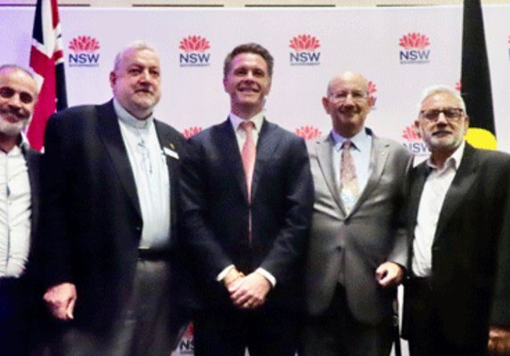 NSW Premier Chris Minns (centre), Jeremy Jones AM (2nd right) and Christian and Muslim guests