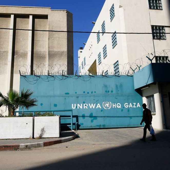 A Palestinian man walks past the building of the UNRWA headquarters in Gaza City on January 8, 2018.
(Photo MOHAMMED ABED/AFP/Getty Images)