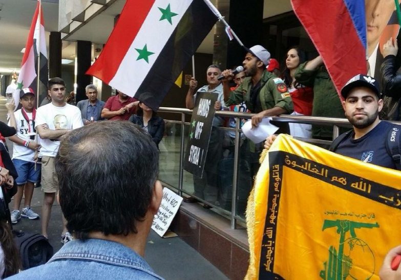 A Hezbollah flag being waved at a protest in Sydney.