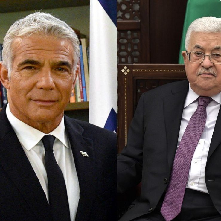 Israeli Prime Minister Yair Lapid (L) and Palestinian President Mahmoud Abbas