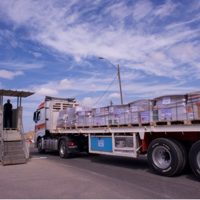 A truck carrying food and other humanitarian aid moves through a security checkpoint at Kerem Shalom, Israel, into the Gaza Strip on March 14 (Image: Charlotte Lawson)
