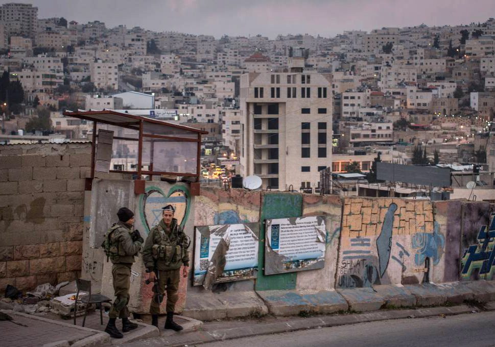 Israeli soldiers man a checkpoint to an Israeli settlement in Hebron in the West Bank. Picture: Getty Images
