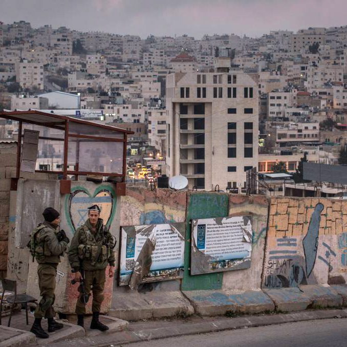 Israeli soldiers man a checkpoint to an Israeli settlement in Hebron in the West Bank. Picture: Getty Images