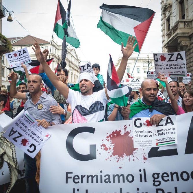 Pro-Palestinian rally in Milan, Italy, with signs promoting the lie that Israel is committing genocide in Gaza (source: Eugenio Marongiu/Shutterstock)
