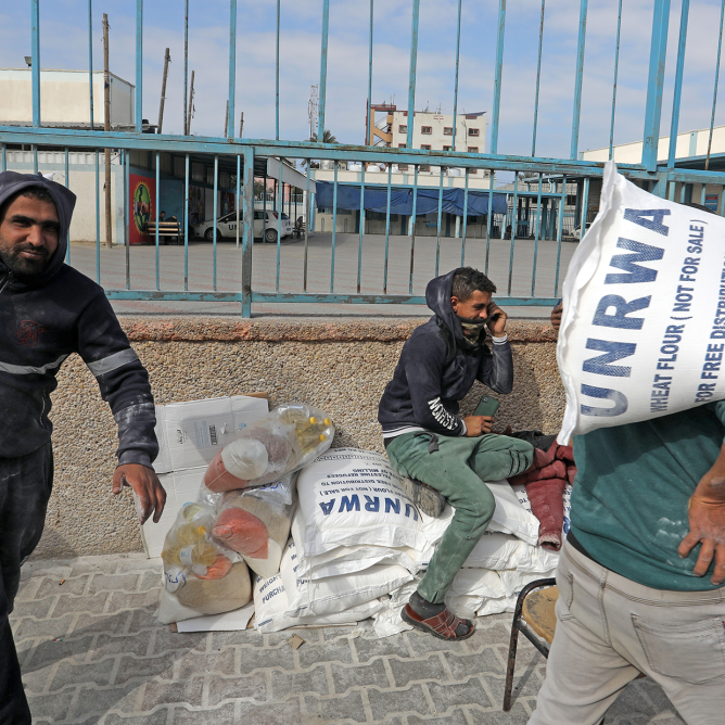 Palestinians receive their food rations from the United Nations Relief and Works Agency (UNRWA) warehouse in the southern Gaza Strip town of Rafah (Image: Shutterstock)