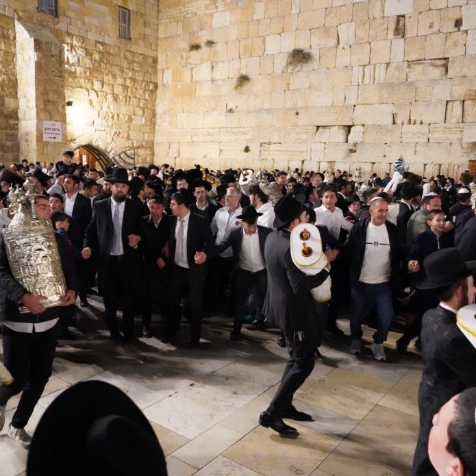 Celebrating with Torah scrolls in Jerusalem (Image: Teo K/ Shutterstock)