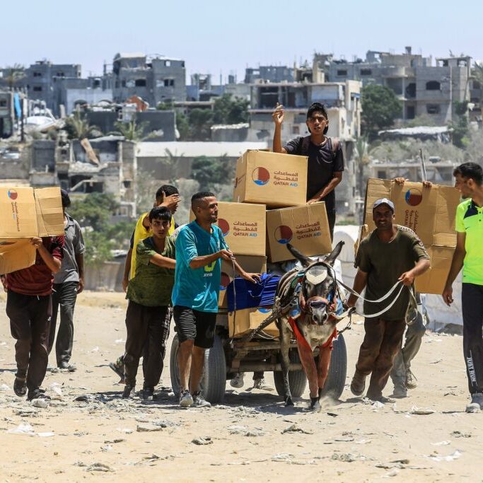 Palestinians carrying food aid received from an aid point in Rafah, southern Gaza Strip (Image: Shutterstock/ Anas Mohammed)