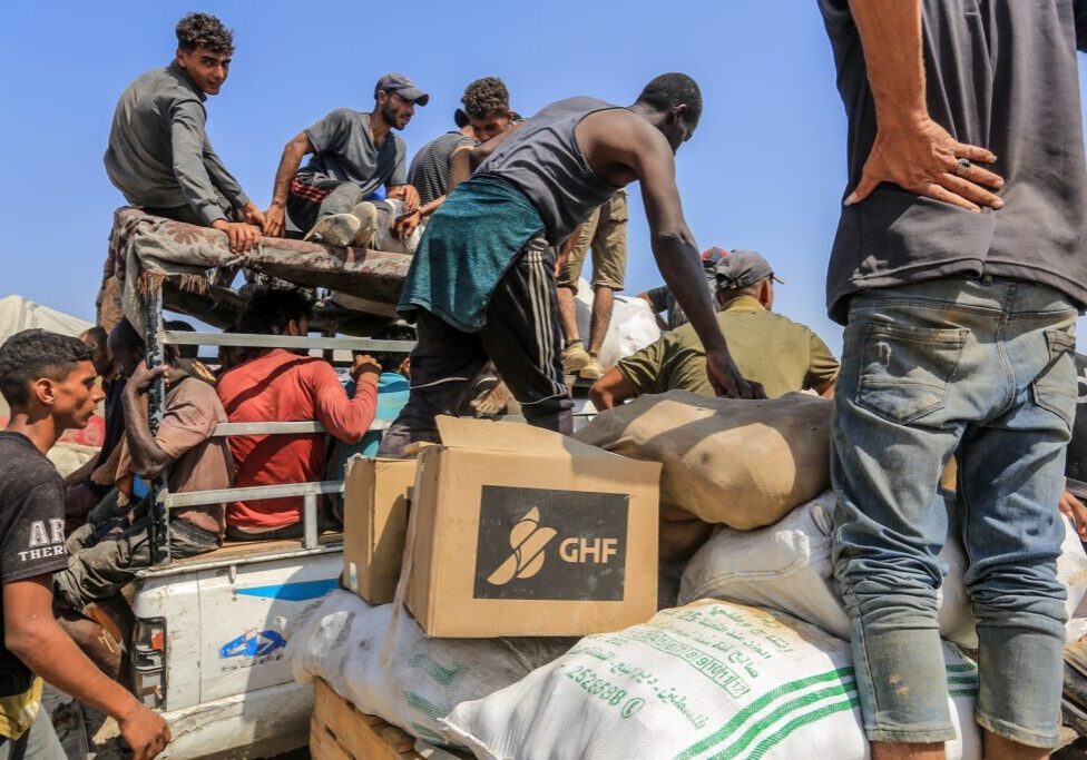 Palestinians receive humanitarian and food aid from the American Center for Humanitarian Aid (GHF), located in Rafah, Gaza Strip, on August 2025 (Image: Shutterstock)