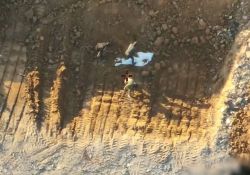 Israeli military drone video shows Hamas operatives burying a white shroud containing hostage remains in Gaza City and then staging its discovery in front of the Red Cross (IDF video screenshot)